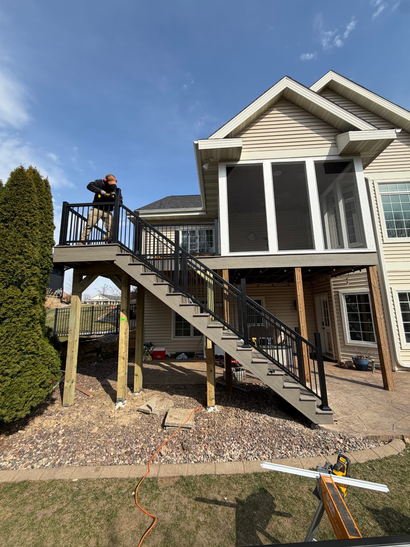 Elevated composite deck with staircase under construction in Sun Prairie WI